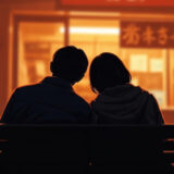 ベンチで肩を寄せ合うカップル